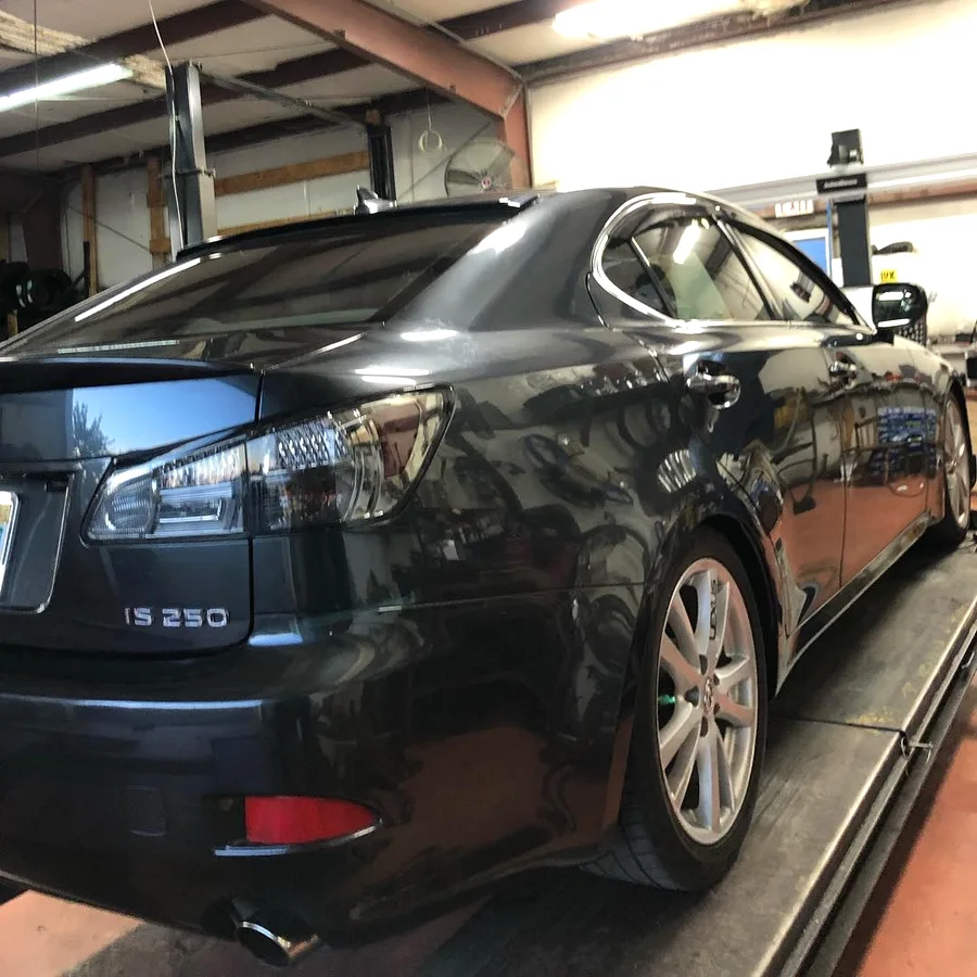 Vehicle up on the alignment rack inside the shop
