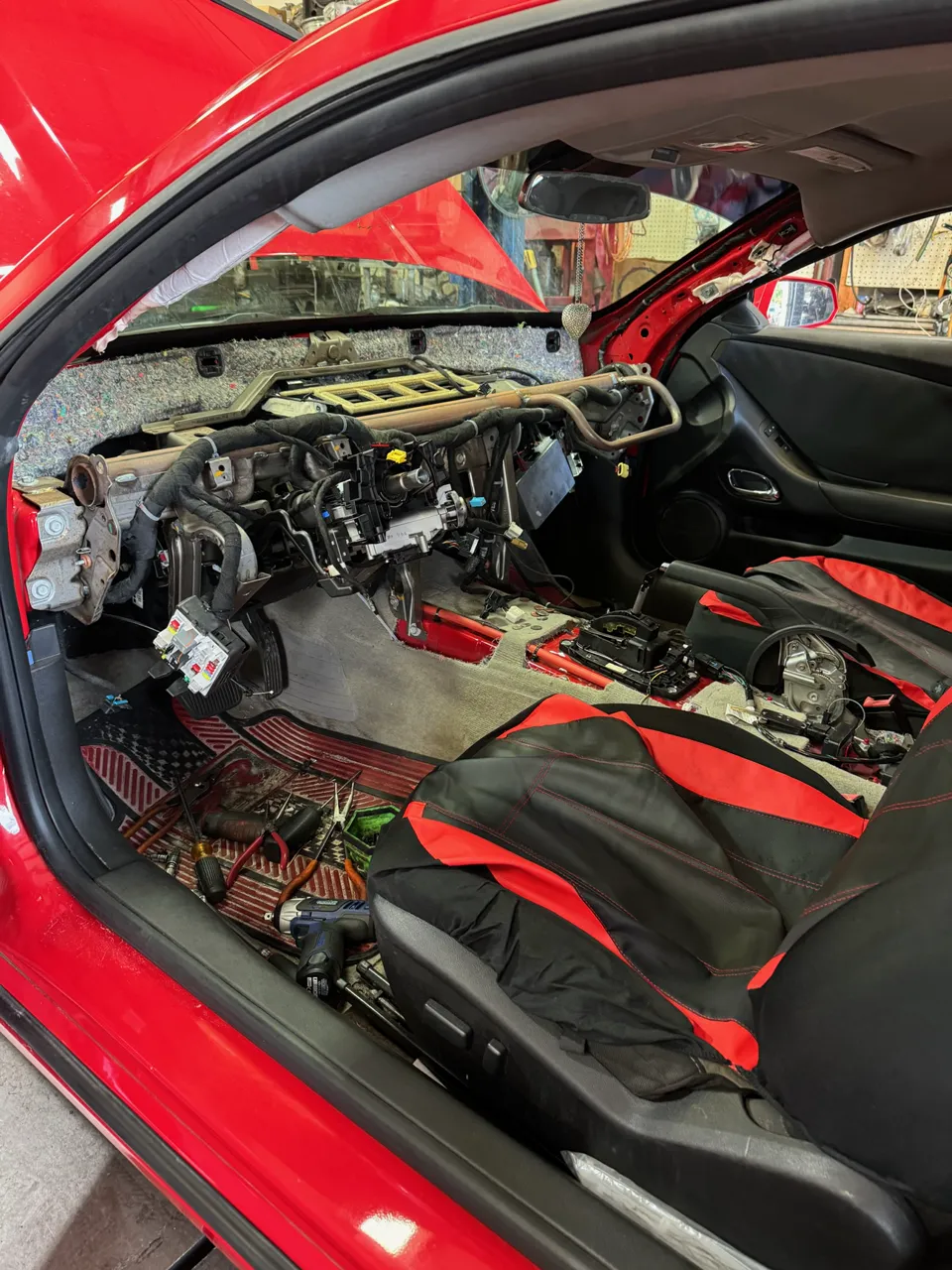 Red Chevrolet dashboard removed for electrical repair