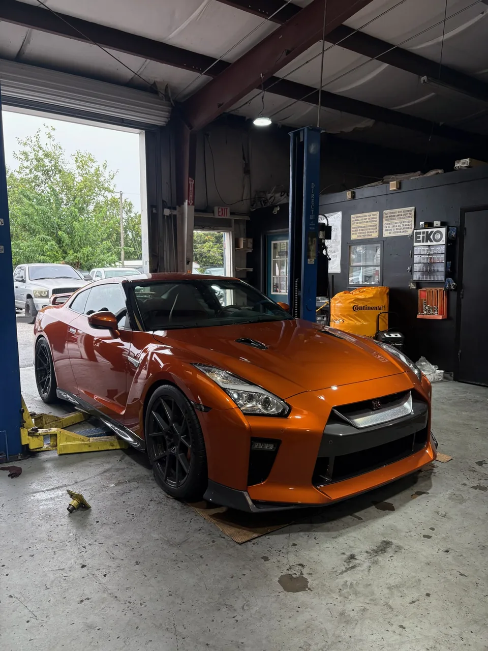 Orange Nissan GT-R in the H&R Automotive shop