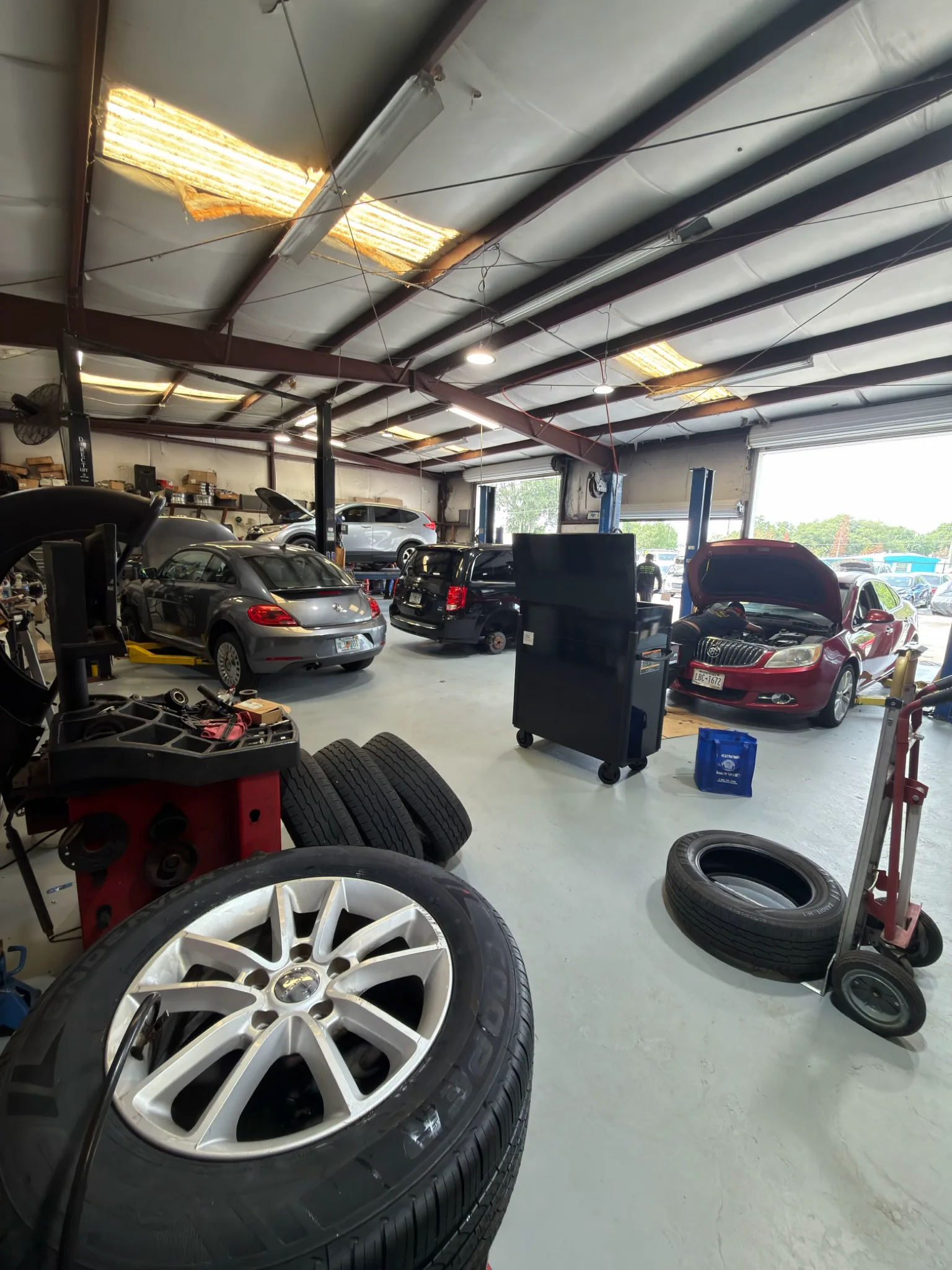 Cars being serviced inside the H&R Automotive shop